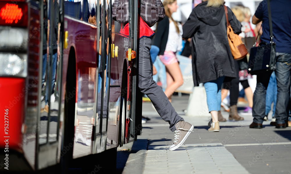 Wall mural Person enters bus