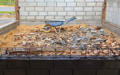 Old rusty wheelbarrow in construction site