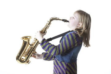 young blond girl with alto saxophone in studio