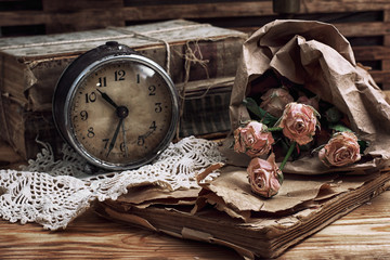 retro bouquet of roses and old-fashioned clock