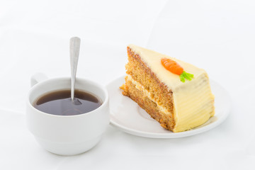 Carrot Cake on white dish with hot drink