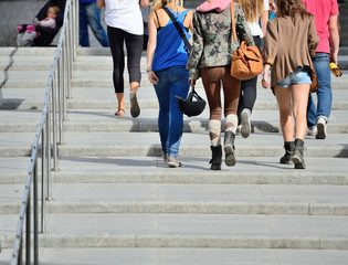 Obraz premium Young people walking up the stairs