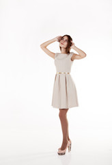 young beautiful girl in a bright dress looking up