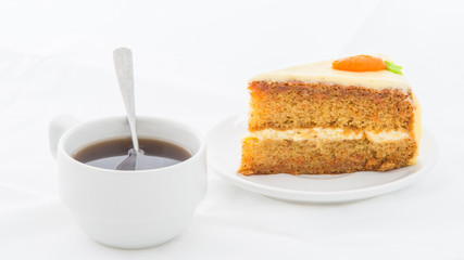Carrot Cake on white dish with hot drink