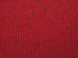 Christmas background from red knitted red wool closeup