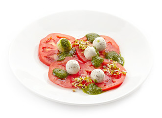 Plate of tomato and goat cheese balls salad
