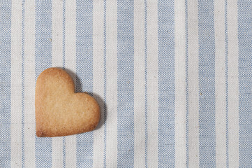 Butter cookies, heart shaped, on a striped fabric napkin