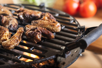 Grilling chicken wings on barbecue grill