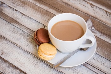 Coffee and macarons on wooden table