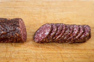 salami sliced on wooden board