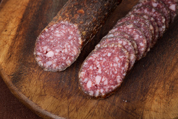 salami sliced on wooden board