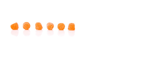 Orange colored sugar jelly candy over white background