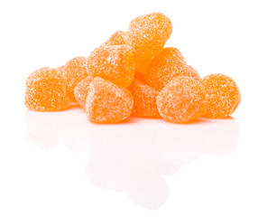 Orange colored sugar jelly candy over white background