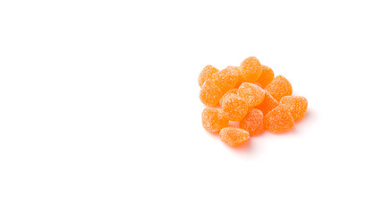 Orange colored sugar jelly candy over white background