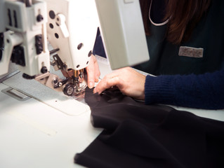 Seamstress sews garments luxury made in italy