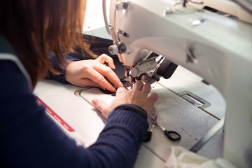 Seamstress sews garments luxury made in italy