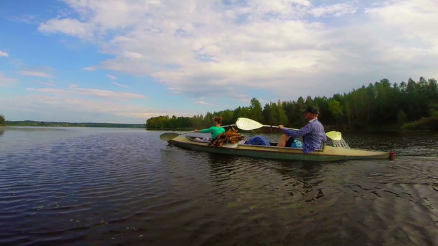 Young girl and guy paddling canoe fast, active lifestyle, sport