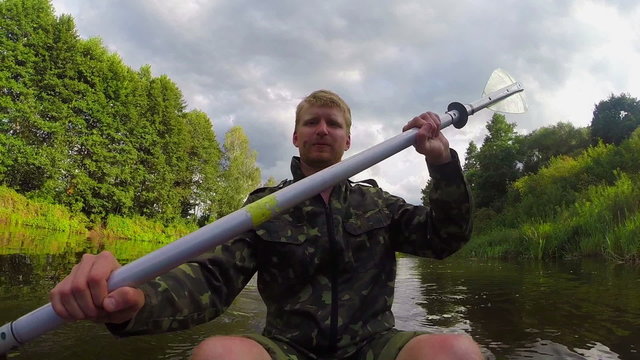 Male tourist kayaking on river, action camera, vacation, slow-mo