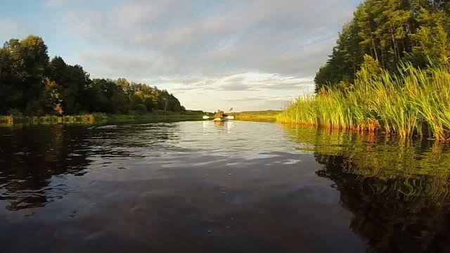 Tourists boating on river at sunset. Beautiful view, slow motion