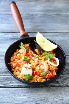 Tasty paella with mussels meat and vegetables