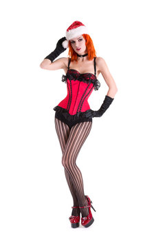 Burlesque girl in red corset and Santa Claus hat