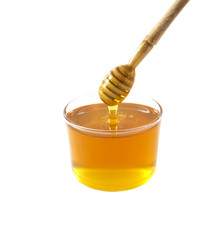 Glass jar of honey with wooden drizzler isolated