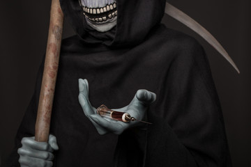 Grim reaper holding syringe with drugs