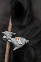 The concept: smoking kills. Angel of death holding cigarette