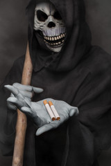 The concept: smoking kills. Grim reaper holding cigarette