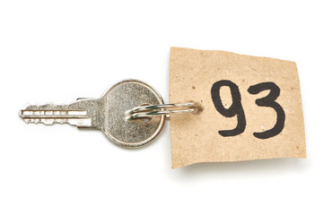 Key with paper trinket isolated