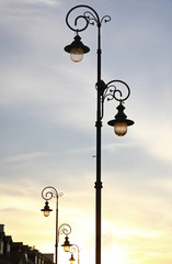Fototapeta na wymiar The retro-styled lamppost on the street of Warsaw, Poland