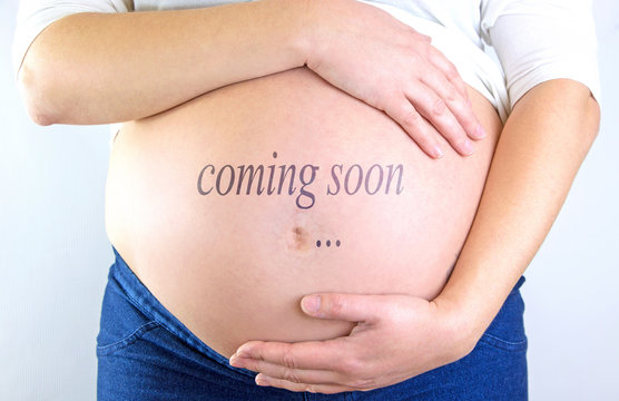 Pregnant woman belly with Coming soon text