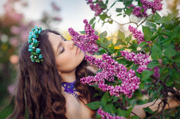 Fototapeta premium beautiful woman in the Spring Park, the smell of lilacs