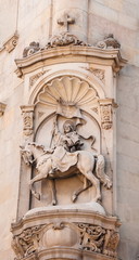 Fototapeta na wymiar Ancient bas-relief on wall of Crusader in Barcelona