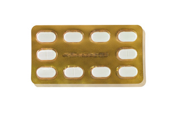 White tablet in gold blister pack