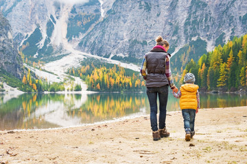 Mother and baby walking on lake braies in south tyrol, italy