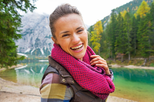 Portrait of happy woman on lake braies in south tyrol, italy