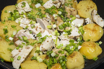 The fried potatoes and chicken with green onions