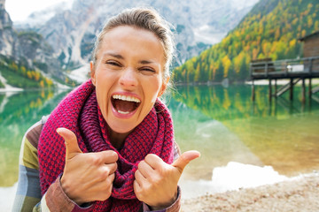 Portrait of happy young woman on lake braies in south tyrol