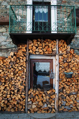 woodpile and window of a typical chalet in italian alps