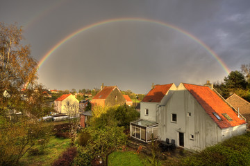 countryside town with rainbow