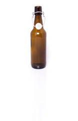 Old brown bottle of beer isolated on white.