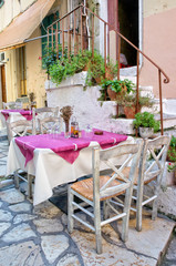 Fototapeta na wymiar Traditional restaurant in a Corfu alley - Greece