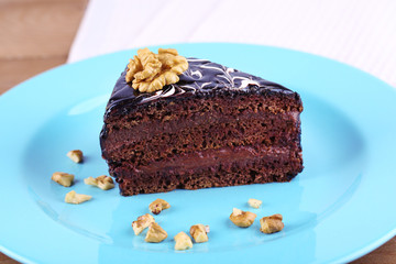 Delicious chocolate cake on plate on table close-up