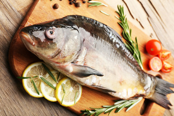 Fresh raw fish and food ingredients on table