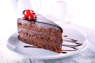 Delicious chocolate cake on plate on table on light background