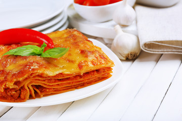 Portion of tasty lasagna on table