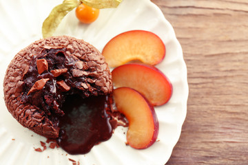 Hot chocolate pudding with fondant centre with fruits, close-up