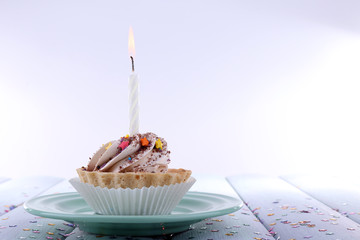 Birthday cup cake with candle with sparkles