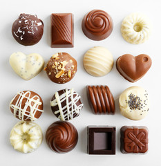Delicious chocolate candies isolated on white